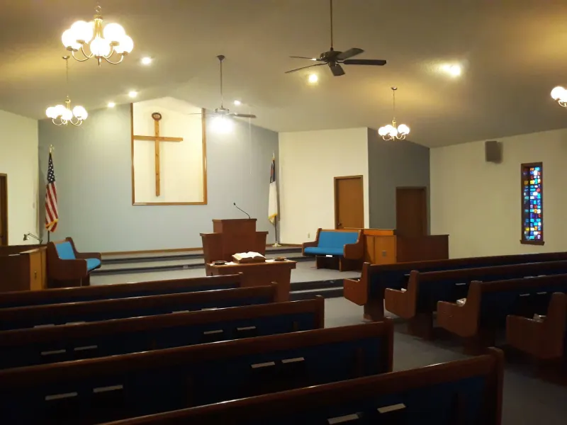 The Briarwood sanctuary with pews facing the wooden cross