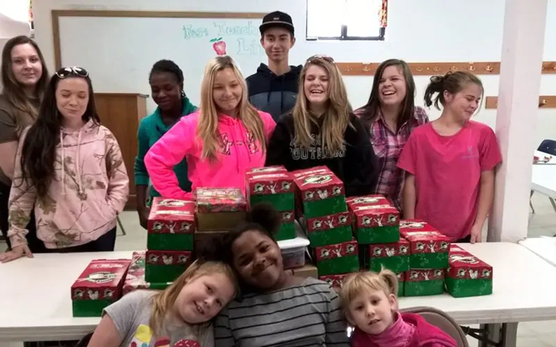 Young people from Briarwood packing gift shoeboxes